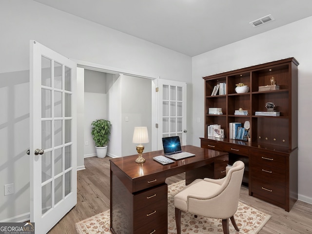 office space with light hardwood / wood-style flooring and french doors