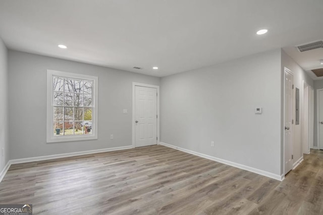 unfurnished room with light hardwood / wood-style floors