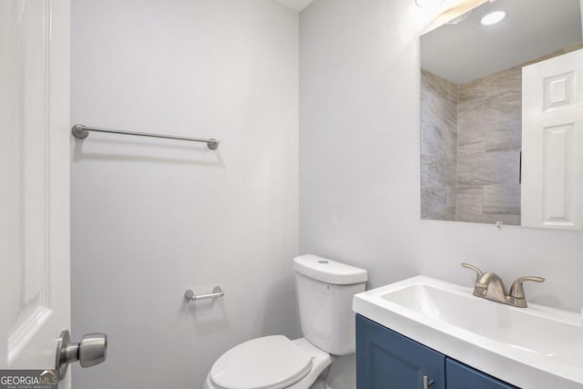 bathroom featuring vanity and toilet