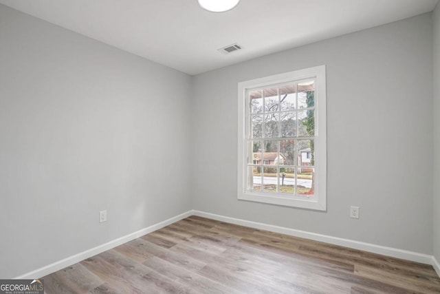 unfurnished room with plenty of natural light and light hardwood / wood-style flooring