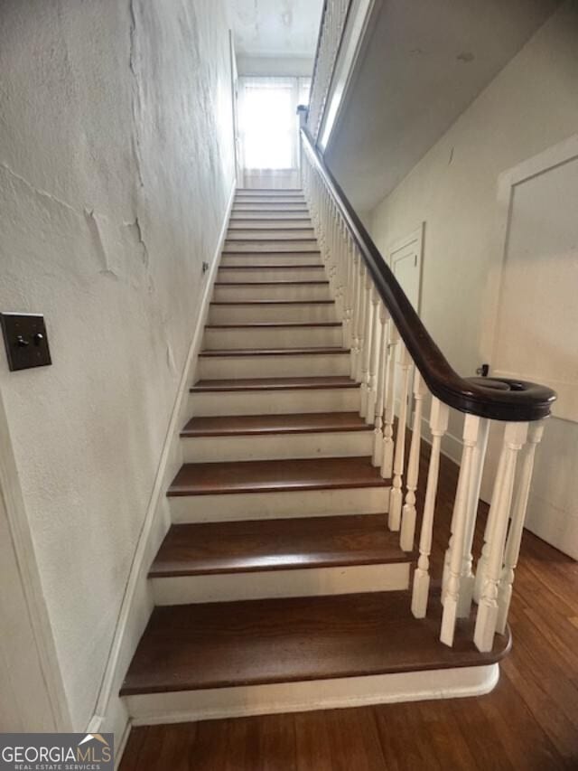 stairway featuring hardwood / wood-style flooring