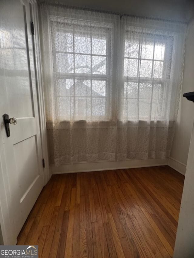 unfurnished room featuring hardwood / wood-style floors