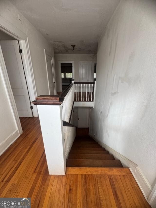 stairs with wood-type flooring