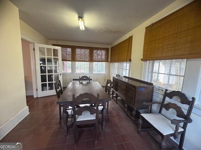 dining space with dark tile patterned flooring