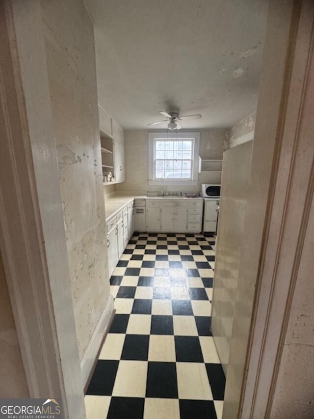 bathroom featuring ceiling fan and sink