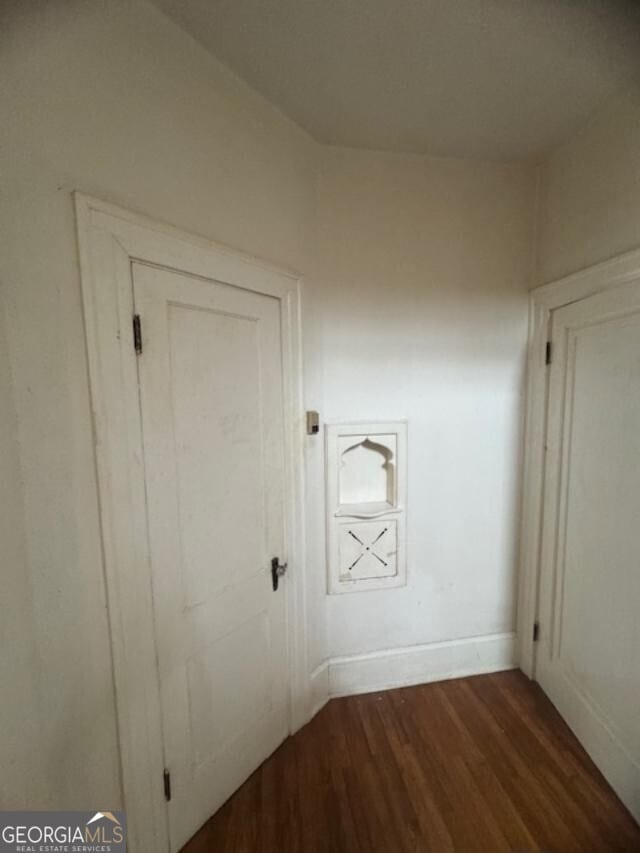 corridor with dark hardwood / wood-style flooring