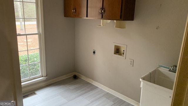 laundry area featuring hookup for a washing machine, electric dryer hookup, and cabinets