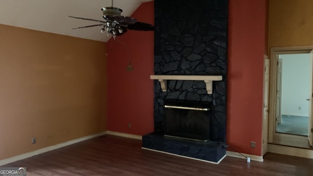 unfurnished living room with vaulted ceiling, dark wood-type flooring, a fireplace, and ceiling fan