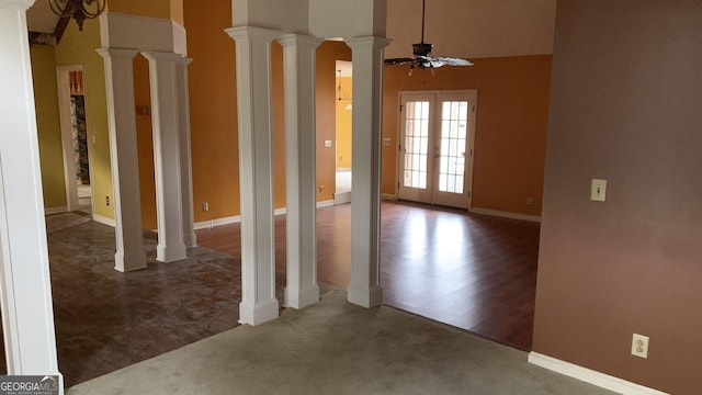 interior space with french doors, dark carpet, and ornate columns