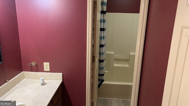 bathroom featuring vanity and shower / bath combination with curtain