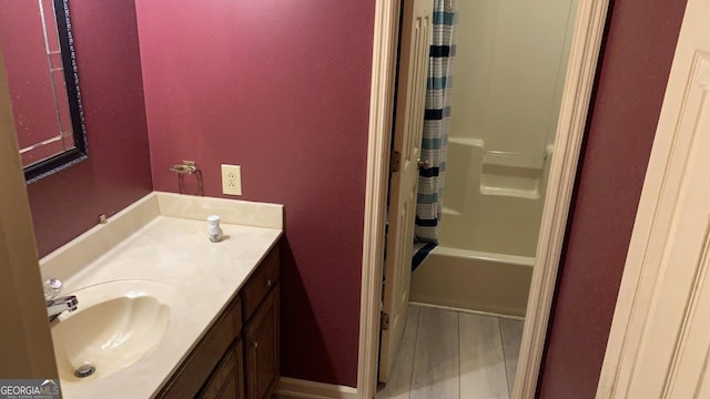 bathroom featuring vanity, hardwood / wood-style floors, and shower / bath combination with curtain