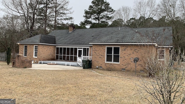 back of house featuring a yard, a sunroom, and a patio