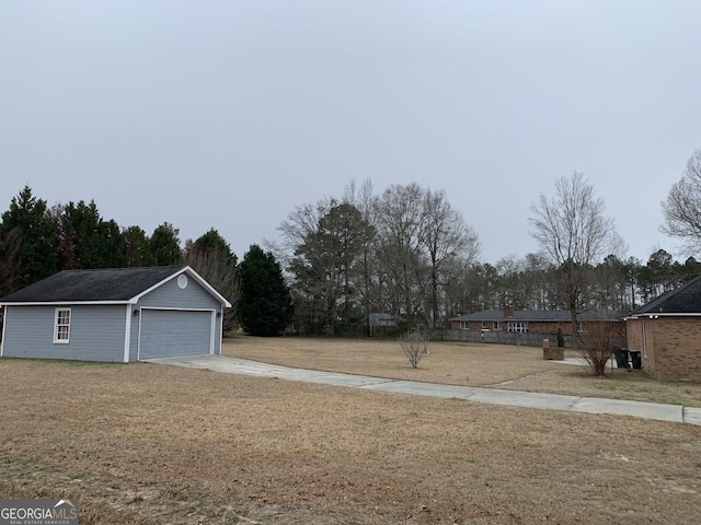 view of yard with a garage and an outdoor structure