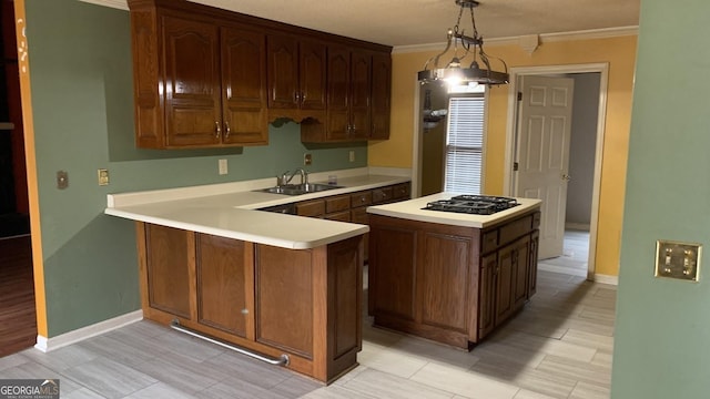 kitchen with sink, hanging light fixtures, black gas cooktop, ornamental molding, and kitchen peninsula