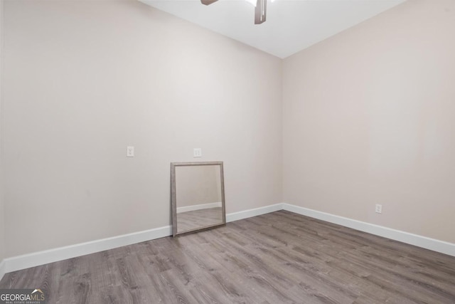 empty room featuring hardwood / wood-style flooring and ceiling fan