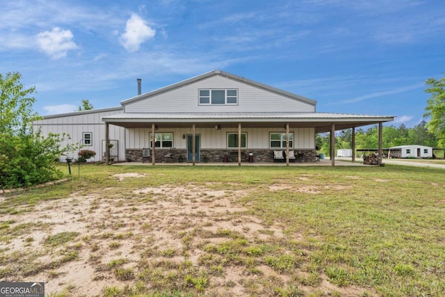 rear view of property featuring a yard