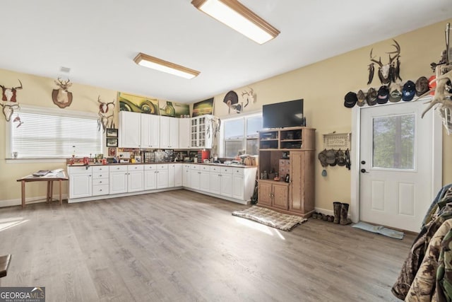 kitchen featuring white cabinetry and light hardwood / wood-style floors