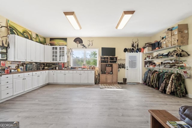 kitchen featuring light hardwood / wood-style flooring and white cabinets