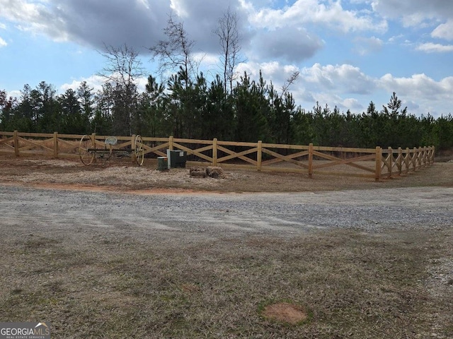 view of gate with a rural view