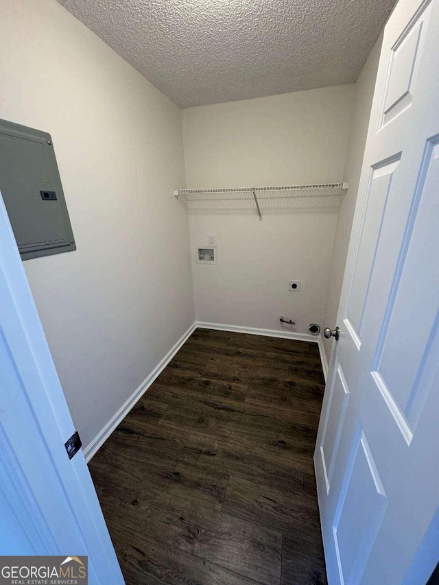 laundry room with dark hardwood / wood-style floors, washer hookup, hookup for an electric dryer, and a textured ceiling