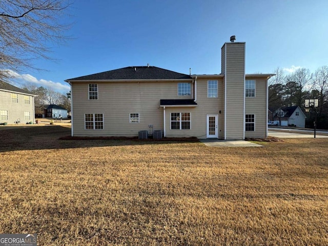 back of property with a patio, cooling unit, and a lawn