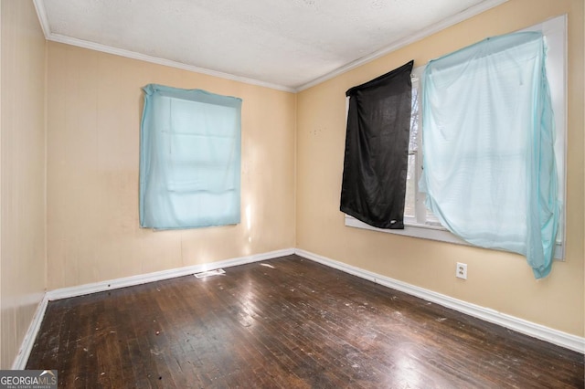 spare room featuring hardwood / wood-style flooring and crown molding