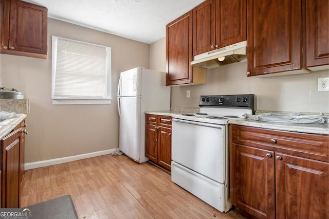 kitchen with white appliances and light wood-type flooring