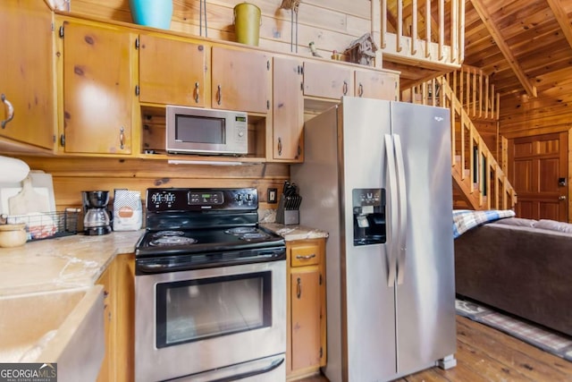 425 River Bend Ct, Ellijay, GA 30540 - kitchen with stainless steel appliances, wood ceiling, light countertops, light wood-style flooring, and wooden walls