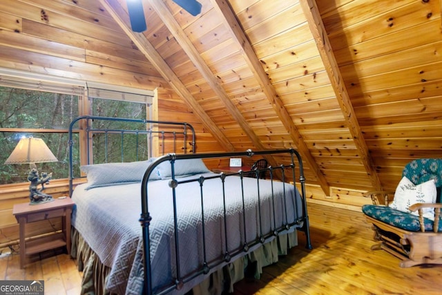 bedroom with lofted ceiling with beams, wood-type flooring, wood ceiling, and wooden walls