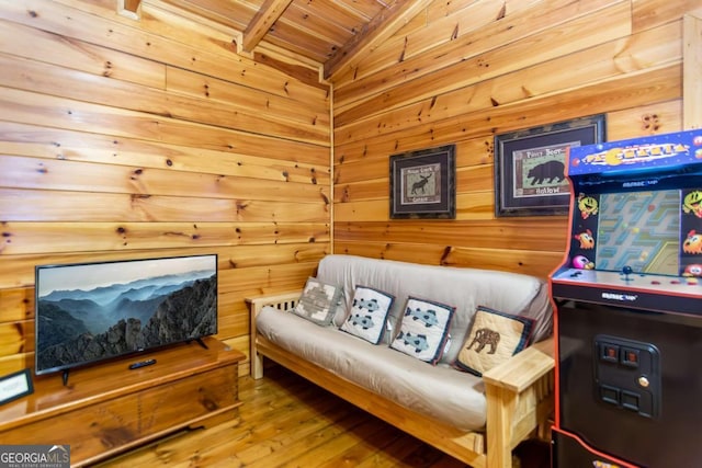 sitting room featuring hardwood / wood-style floors, wood ceiling, vaulted ceiling, and wooden walls