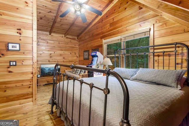 bedroom featuring light hardwood / wood-style flooring, vaulted ceiling with beams, wood ceiling, and wooden walls