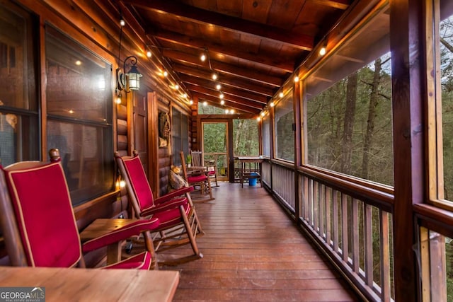 sunroom with vaulted ceiling with beams and wood ceiling