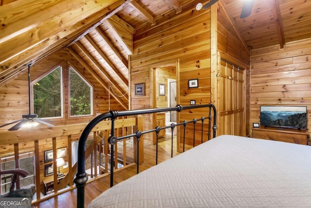 bedroom featuring hardwood / wood-style flooring, vaulted ceiling with beams, wooden ceiling, and wood walls