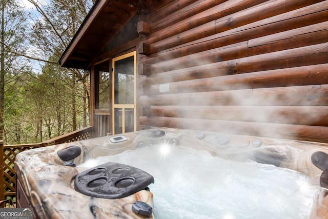 wooden terrace with a hot tub