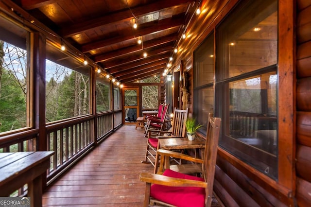 sunroom with wood ceiling and vaulted ceiling with beams