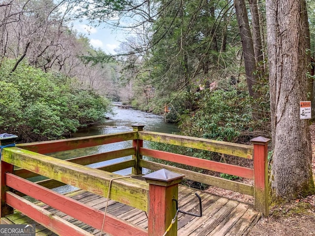 wooden terrace featuring a water view