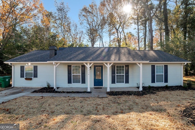 single story home with a front yard and covered porch