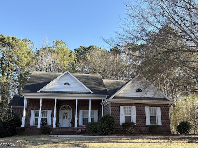 greek revival house with covered porch and brick siding