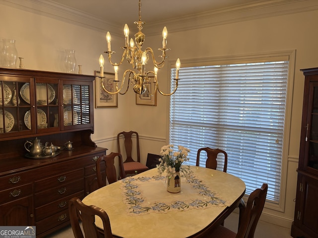 dining space with a chandelier and ornamental molding