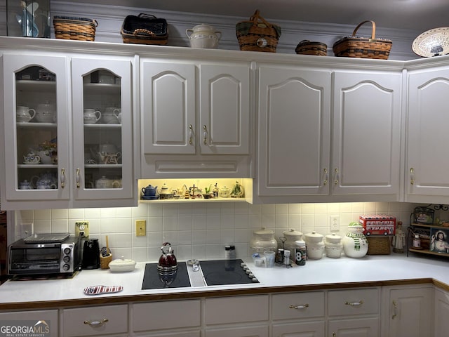 bar with white cabinetry, tasteful backsplash, and black electric cooktop