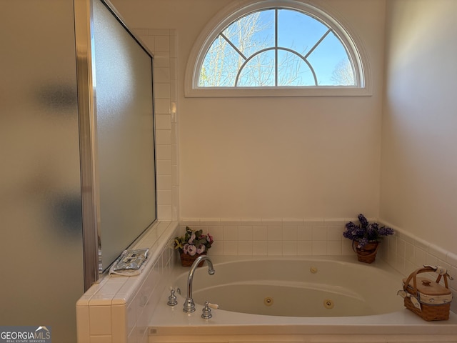 full bath with a healthy amount of sunlight and a whirlpool tub