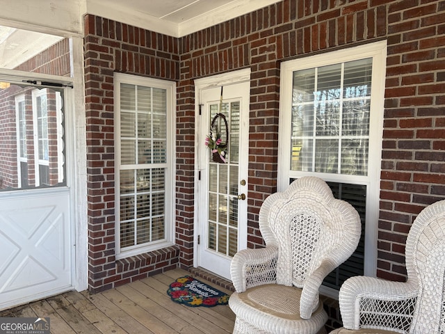 view of exterior entry featuring brick siding