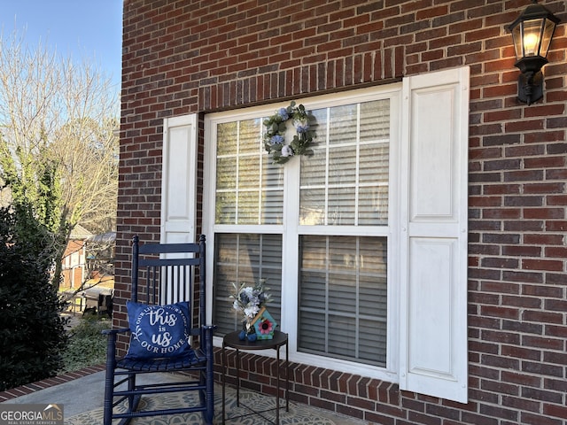 view of exterior entry with brick siding