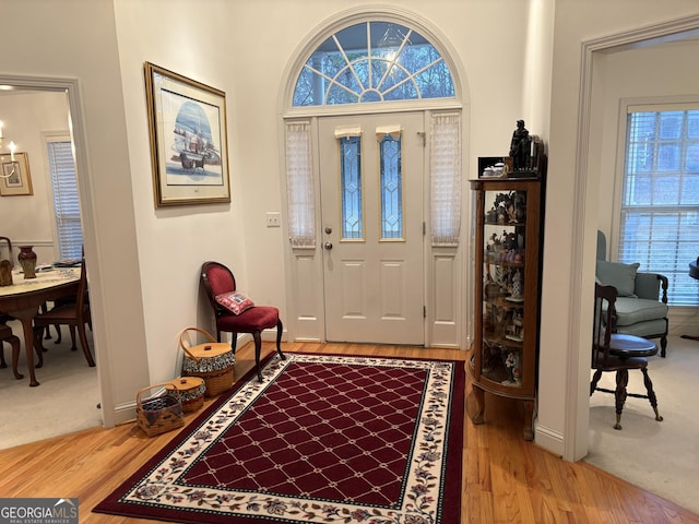 foyer entrance featuring wood finished floors and baseboards