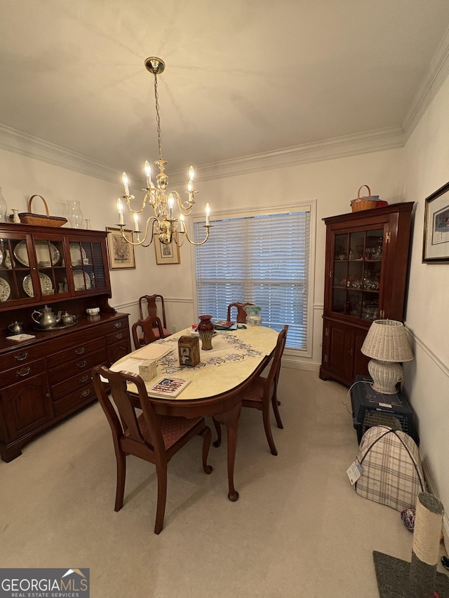 dining room with an inviting chandelier, light colored carpet, and ornamental molding