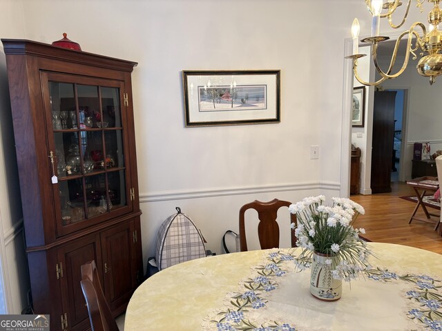 dining room with an inviting chandelier and wood finished floors