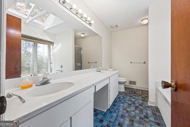 full bathroom featuring toilet, plus walk in shower, vanity, and a skylight