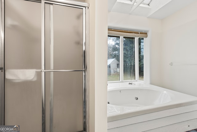 bathroom featuring shower with separate bathtub