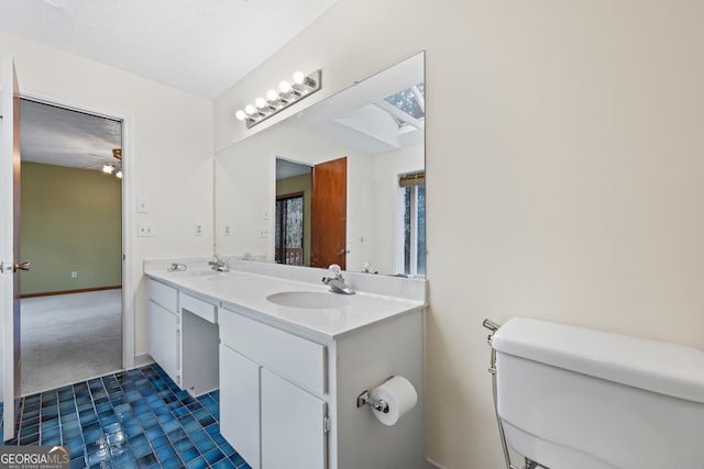 bathroom featuring tile patterned floors, vanity, and toilet