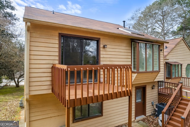 back of property featuring a wooden deck and central air condition unit